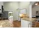 Spacious kitchen features granite counters, stainless appliances, breakfast bar, and views to living area at 4445 Ansley Ln, Cumming, GA 30040