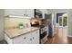 Updated kitchen features stainless steel appliances, tile backsplash, and light countertops, offering modern convenience at 4445 Ansley Ln, Cumming, GA 30040