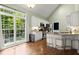 Well-lit kitchen includes stainless appliances, granite countertops, breakfast bar, and a large window overlooking the yard at 4445 Ansley Ln, Cumming, GA 30040