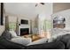 Bright living room featuring a fireplace, built-ins, and large windows at 4445 Ansley Ln, Cumming, GA 30040