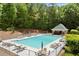 Community pool with ample lounge chairs, sun umbrellas, mature trees, and a beautiful shaded pavilion at 4445 Ansley Ln, Cumming, GA 30040