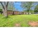 A beautiful backyard with a brick home, lush greenery, perfect for relaxing, playing, and entertaining at 5964 W Fayetteville Rd, Atlanta, GA 30349