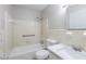 Bathroom featuring a shower-tub combo, toilet, sink and mirror at 5964 W Fayetteville Rd, Atlanta, GA 30349