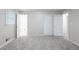 This bedroom features neutral walls, plush gray carpet, a window, and closet space at 5964 W Fayetteville Rd, Atlanta, GA 30349