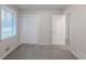 This bedroom features neutral walls, plush gray carpet, and closet space at 5964 W Fayetteville Rd, Atlanta, GA 30349