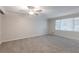 Neutral bedroom with carpet, a ceiling fan, and a large window for natural light at 5964 W Fayetteville Rd, Atlanta, GA 30349