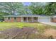 Charming brick ranch home featuring a front porch and well-manicured landscaping at 5964 W Fayetteville Rd, Atlanta, GA 30349
