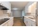 Modern kitchen with white cabinets, stainless appliances, and wood flooring at 5964 W Fayetteville Rd, Atlanta, GA 30349