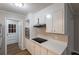 Bright kitchen with stainless steel oven and cooktop, white cabinets, and modern countertops at 5964 W Fayetteville Rd, Atlanta, GA 30349