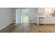 Open living space featuring new flooring, white trim, and a sliding glass door at 5964 W Fayetteville Rd, Atlanta, GA 30349