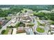 Aerial view of a commercial district with shops, parking, and surrounding streets at 663 Warm Springs Ct, Loganville, GA 30052