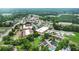 Aerial view of town buildings nestled among trees and a green landscape at 663 Warm Springs Ct, Loganville, GA 30052