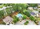 Aerial view of a community clubhouse, pool and surrounding homes with mature trees and a pond at 663 Warm Springs Ct, Loganville, GA 30052