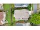 Aerial view of a private backyard, showcasing a patio and mature landscaping at 663 Warm Springs Ct, Loganville, GA 30052
