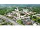 Aerial shot showcases a town square area, traffic, surrounding businesses and buildings at 663 Warm Springs Ct, Loganville, GA 30052