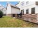 The backyard features a brick patio with space for grilling and a grassy area for outdoor activities at 663 Warm Springs Ct, Loganville, GA 30052