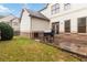 The backyard features a brick patio with space for grilling and a grassy area for outdoor activities at 663 Warm Springs Ct, Loganville, GA 30052