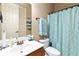 Bathroom featuring single sink vanity and a shower with blue patterned curtain at 663 Warm Springs Ct, Loganville, GA 30052