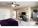 Bedroom featuring a ceiling fan, windows, and a cozy bed with purple linens at 663 Warm Springs Ct, Loganville, GA 30052