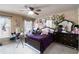 Bright bedroom with a ceiling fan, large windows, and a cozy bed with purple linens at 663 Warm Springs Ct, Loganville, GA 30052