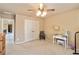 Bedroom with neutral walls, carpet, ceiling fan, double-door closet, desk, and chair at 663 Warm Springs Ct, Loganville, GA 30052