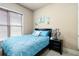 Cozy bedroom featuring a comfortable bed with blue linens and a matching bedside table at 663 Warm Springs Ct, Loganville, GA 30052