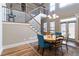 Bright dining area with stylish wooden table, staircase view, and elegant lighting, perfect for entertaining guests at 663 Warm Springs Ct, Loganville, GA 30052