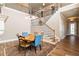 Bright dining area with stylish wooden table, staircase view, and elegant lighting, perfect for entertaining guests at 663 Warm Springs Ct, Loganville, GA 30052