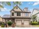 Charming two-story home featuring a two-car garage, landscaped yard, and inviting covered porch at 663 Warm Springs Ct, Loganville, GA 30052