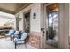 Inviting front porch with seating area, decorative glass door, and brick accents for added curb appeal at 663 Warm Springs Ct, Loganville, GA 30052