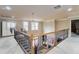 Second story hallway with wood and iron railing overlooking the living room at 663 Warm Springs Ct, Loganville, GA 30052