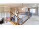 Spacious hallway with decorative railings and carpet provides an open and inviting transition between rooms at 663 Warm Springs Ct, Loganville, GA 30052