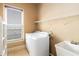 Bright laundry room with white appliances, shelving, and a utility sink offers functionality and convenience at 663 Warm Springs Ct, Loganville, GA 30052