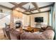 Open-concept living room with brick fireplace, hardwood floors, and coffered ceiling design at 663 Warm Springs Ct, Loganville, GA 30052