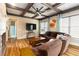 Inviting living room featuring a cozy fireplace, coffered ceilings, and comfortable brown sofa at 663 Warm Springs Ct, Loganville, GA 30052