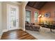 Welcoming living room featuring hardwood floors, elegant decor, and plenty of natural light through large windows at 663 Warm Springs Ct, Loganville, GA 30052