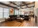 Spacious living room open to kitchen with hardwood floors, brick fireplace, and natural light at 663 Warm Springs Ct, Loganville, GA 30052