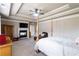 Main bedroom with ceiling fan, fireplace, sitting area, and neutral-colored carpet at 663 Warm Springs Ct, Loganville, GA 30052