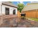 This brick patio features stone pavers, a wood fence, and plenty of space for outdoor dining and entertaining at 663 Warm Springs Ct, Loganville, GA 30052