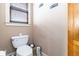This home's powder room is equipped with a window for natural light and wall art for an elegant touch at 663 Warm Springs Ct, Loganville, GA 30052