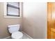 Bathroom toilet with a window to let in natural light at 663 Warm Springs Ct, Loganville, GA 30052
