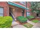 Exterior building entrance with a staircase, greenery, and brick facade with a green awning at 791 Wylie Se St # 410, Atlanta, GA 30316