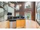 Stylish kitchen showcases granite countertops, stainless dishwasher, and ample lighting and spiral staircase at 791 Wylie Se St # 410, Atlanta, GA 30316