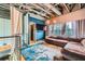 Upstairs den area offering a stylish sectional sofa, TV, and exposed beam ceiling at 791 Wylie Se St # 410, Atlanta, GA 30316