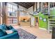 Open-concept living area boasts exposed ceiling, large windows, spiral staircase, and modern decor at 791 Wylie Se St # 410, Atlanta, GA 30316
