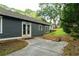 Backyard featuring a concrete patio with outdoor seating, brick stairs to the grassy yard, and a dark-colored house at 23 Clifton Ne St, Atlanta, GA 30317