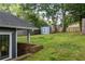 Large backyard with a storage shed and a partial view of the house and lawn at 23 Clifton Ne St, Atlanta, GA 30317