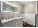 Elegant bathroom featuring a double sink vanity with marble countertops and a large, illuminated mirror at 23 Clifton Ne St, Atlanta, GA 30317