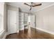 Bedroom with hardwood floors, ceiling fan, built in bookshelves and access to an outdoor patio at 23 Clifton Ne St, Atlanta, GA 30317