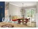 Bright dining area with a wooden table, colorful seating, and French doors to the outside at 23 Clifton Ne St, Atlanta, GA 30317